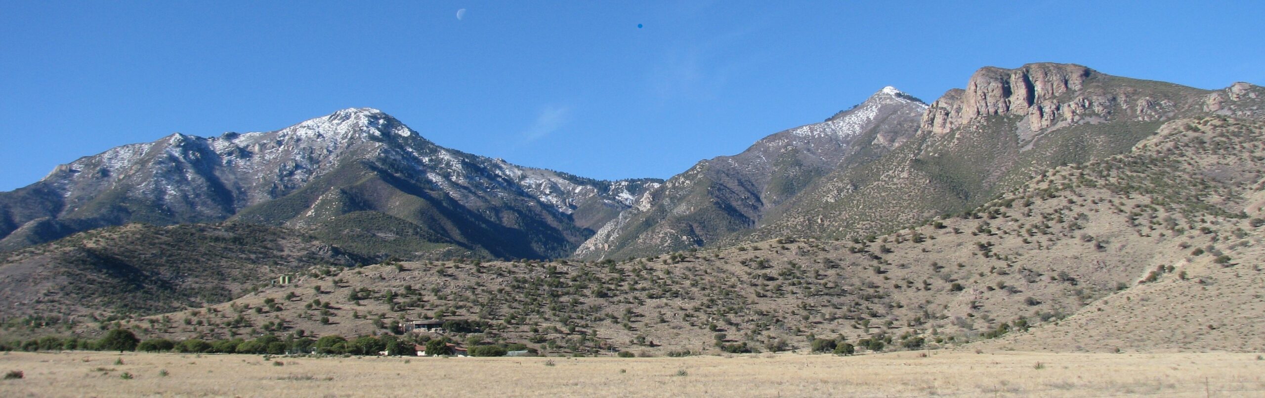 A view of mountains with snow on the top.