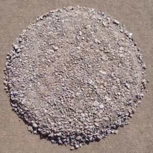 Pile of coarse sand on a surface.